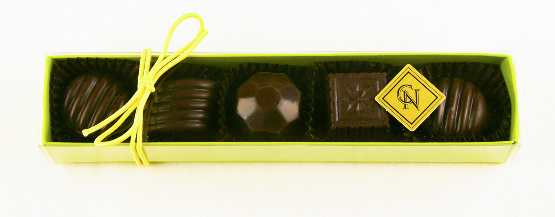 The Green box of Fabulous 5 Dark Chocolate Truffles features: Blood Orange, Wild Berry, Quebec Maple, Burnt Caramel, Chocolate Lime by Christopher Norman Chocolates