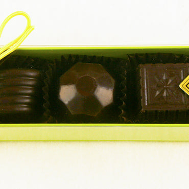 The Green box of Fabulous 5 Dark Chocolate Truffles features: Blood Orange, Wild Berry, Quebec Maple, Burnt Caramel, Chocolate Lime by Christopher Norman Chocolates