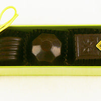 The Green box of Fabulous 5 Dark Chocolate Truffles features: Blood Orange, Wild Berry, Quebec Maple, Burnt Caramel, Chocolate Lime by Christopher Norman Chocolates