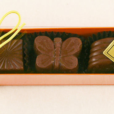 Orange Box:  Milk Chocolate Almond, Cappuccino, Hazelnut Lemon, Milk Chocolate Caramel by Christopehr Norman Chocolates