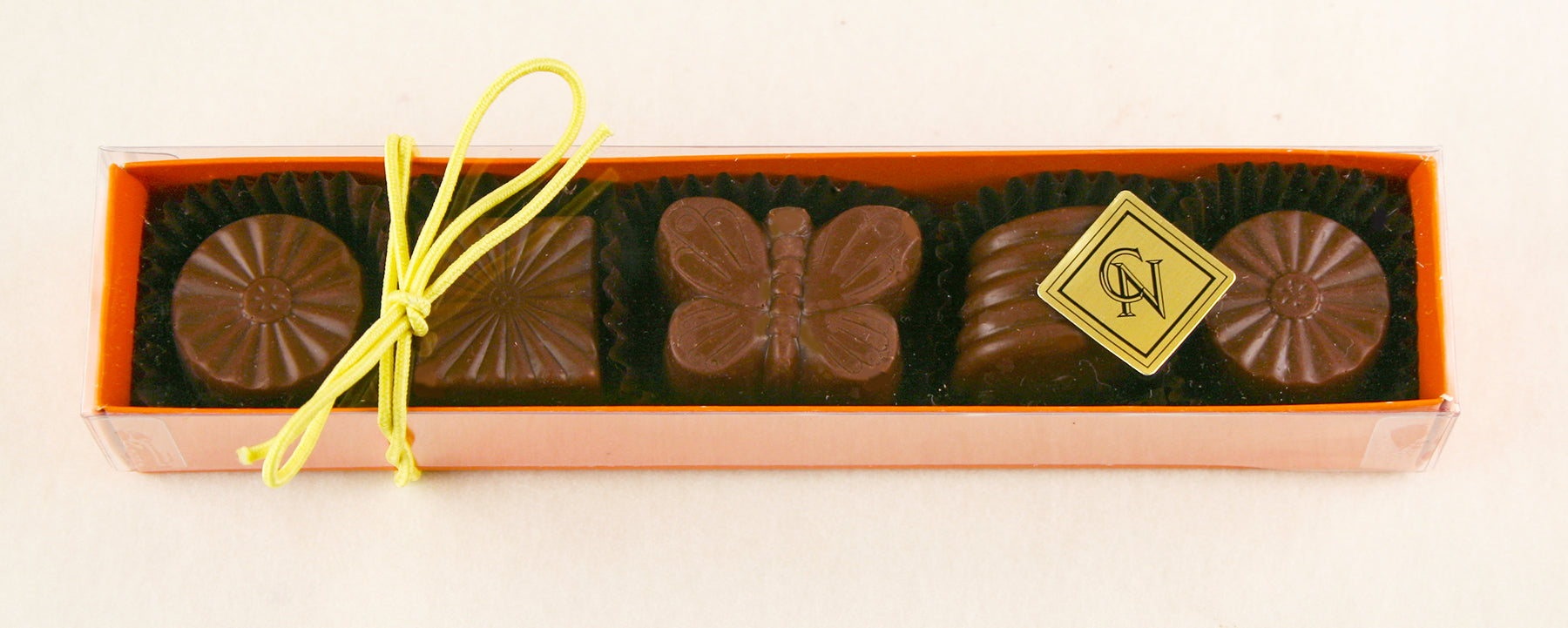 Orange Box:  Milk Chocolate Almond, Cappuccino, Hazelnut Lemon, Milk Chocolate Caramel by Christopehr Norman Chocolates