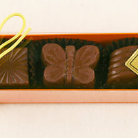 Orange Box:  Milk Chocolate Almond, Cappuccino, Hazelnut Lemon, Milk Chocolate Caramel by Christopehr Norman Chocolates
